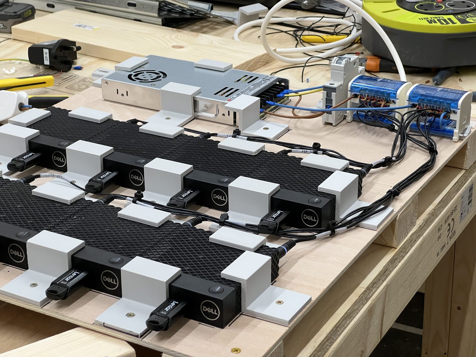 Rows of thin clients mounted on 3D-printed brackets and wired into a cluster