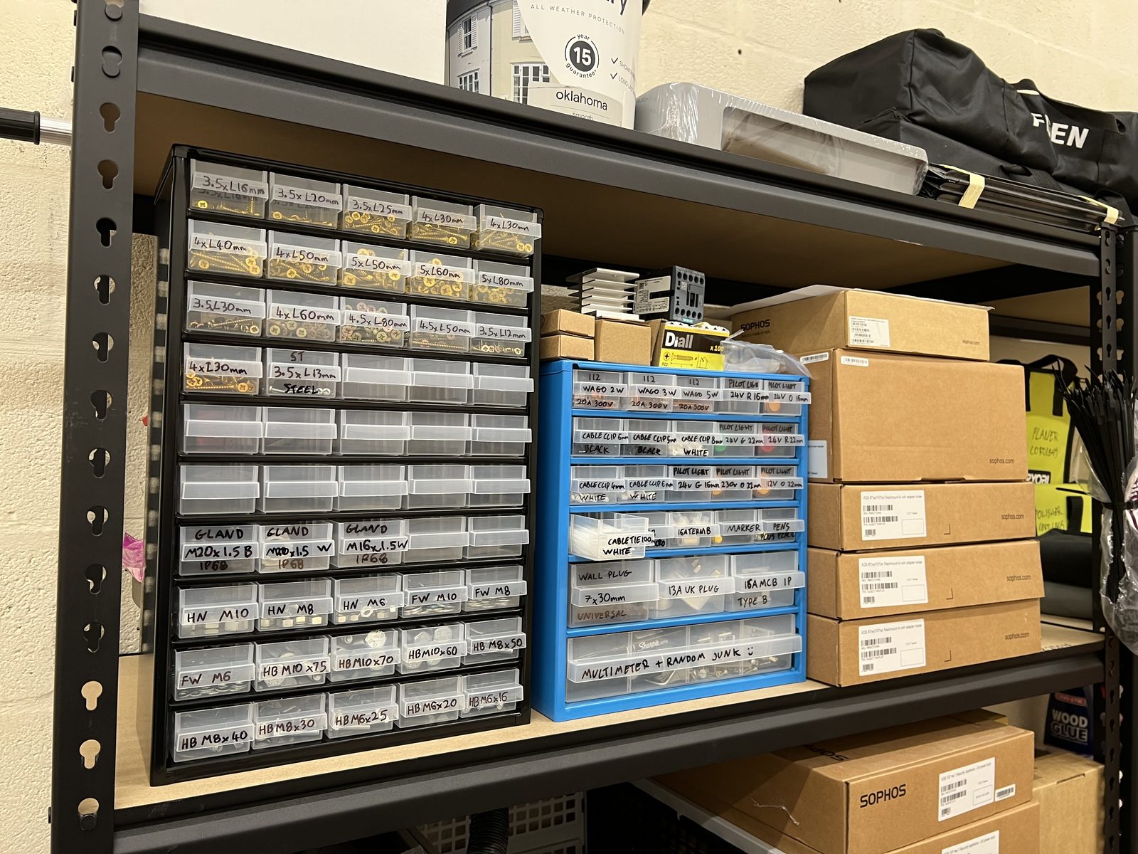 Shelving filled with labelled drawers of screws, connectors, clips and workshop spares