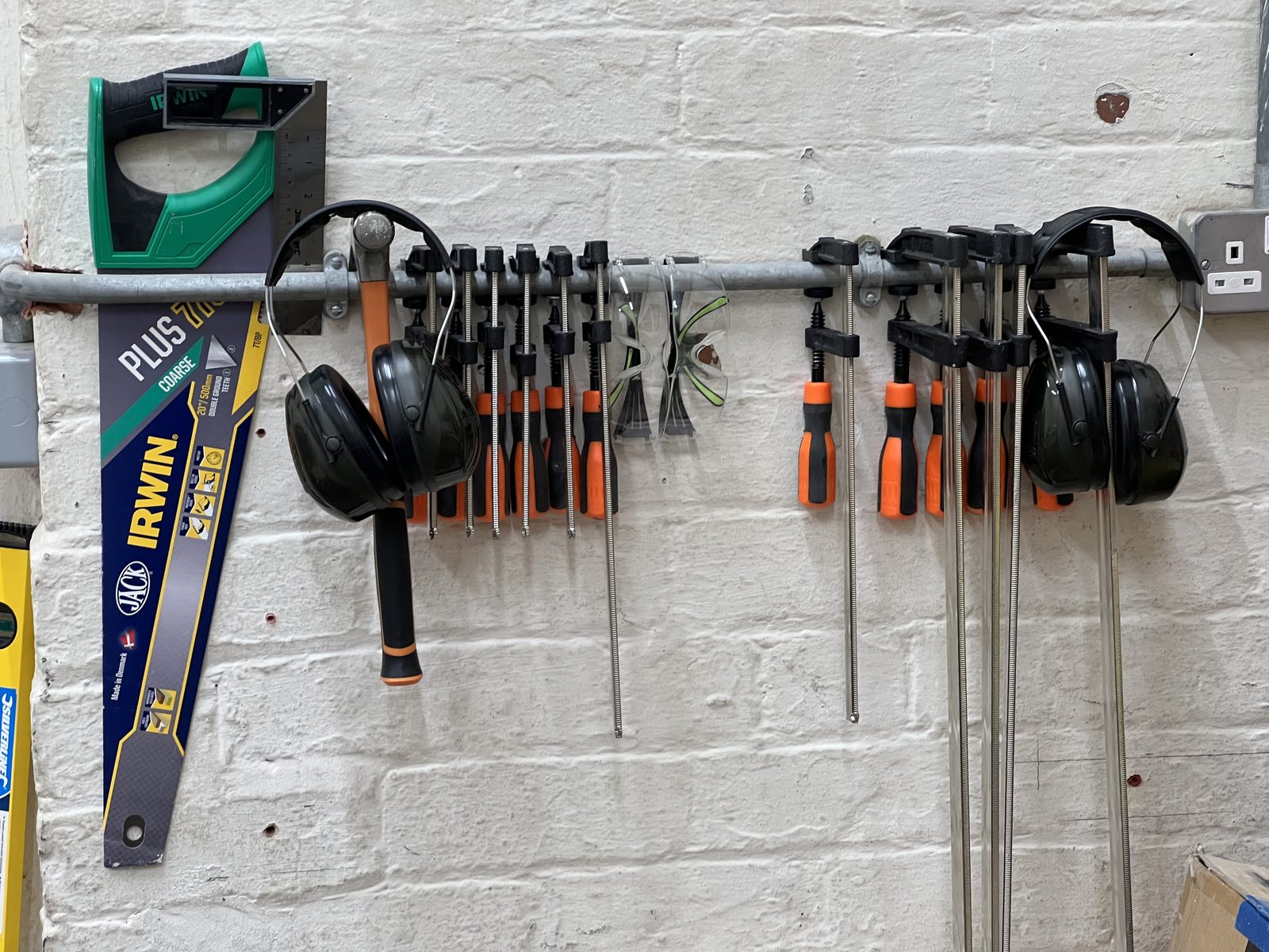 Saws, clamps, screwdrivers and safety equipment arranged on the Carlisle makerspace tool wall